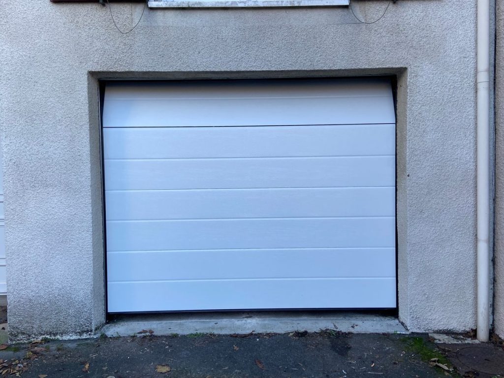 Porte garage sectionnelle blanche rainuree pose renovation maison